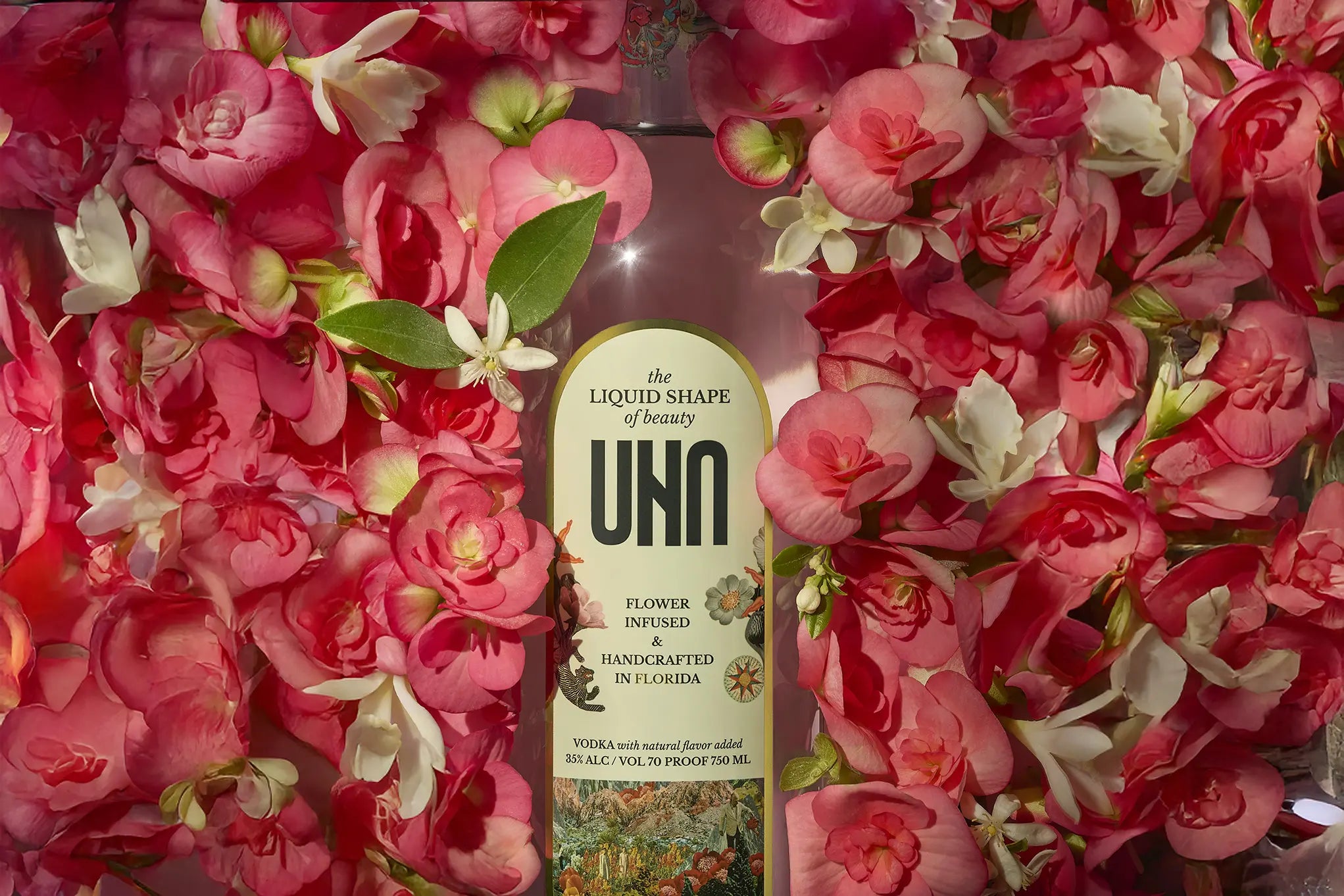 UNA Vodka, flower-infused vodka bottle with begonia flowers surrounding it